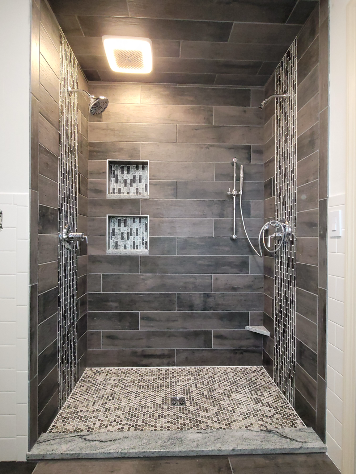 Custom gray tile walk-in shower with built-in niches by Hukill Tile & Design